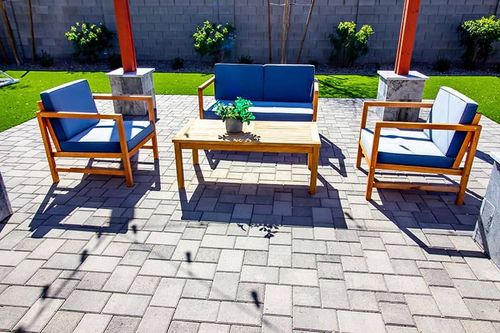 modern paver patio with grey pavers and patio furniture